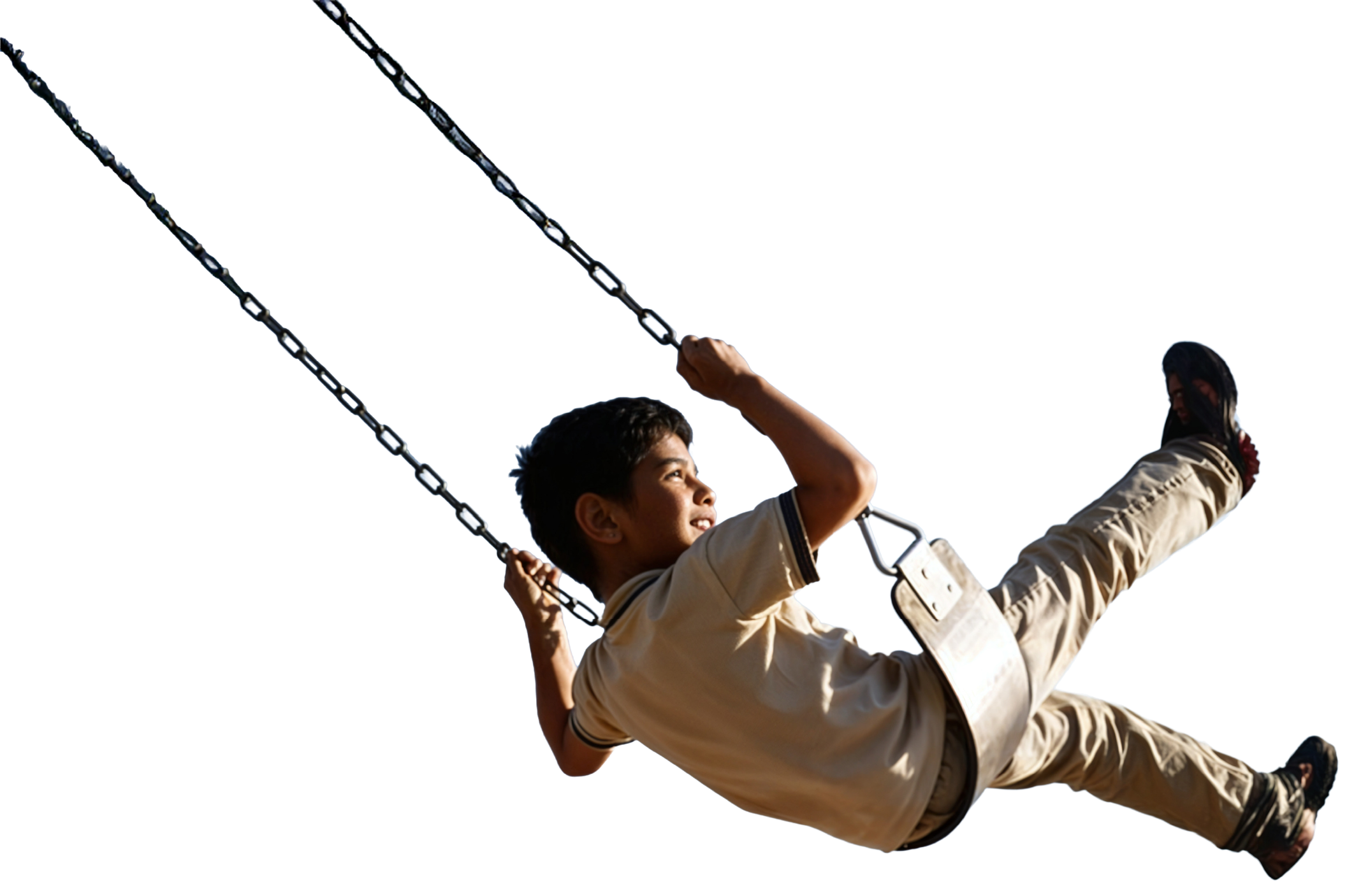 A schoolboy mid-swing on a playground swing, chains extending upward